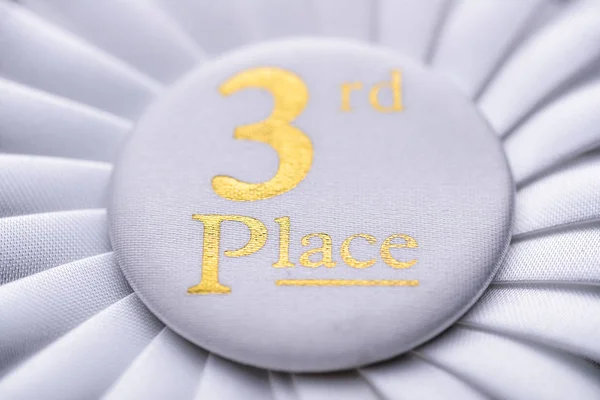 Third place winners white rosette with gold text — Stock Photo, Image