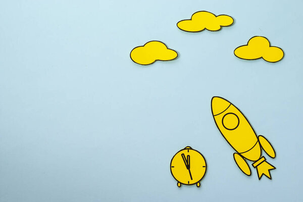 Little yellow rocket speeding through space blue sky background