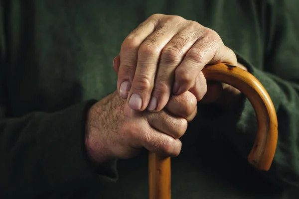 Senior disabled man clasping his walking stick — Stock Photo, Image