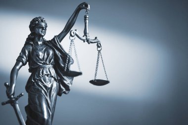 Figure of Justice holding scales and a sword clipart