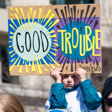 Participants in the March for Our Lives, a protest by students for gun control, hold signs on March 24, 2018 in Washington DC   clipart