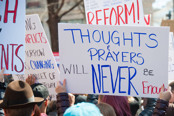 Participants in the March for Our Lives, a protest by students for gun control, hold signs on March 24, 2018 in Washington DC  