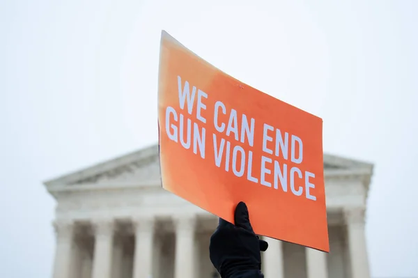 A participant in the Gun Laws Save Lives Rally, a protest against the weakening of gun laws, holds a sign on December 2, 2019 at the U.S. Supreme Court in Washington DC
