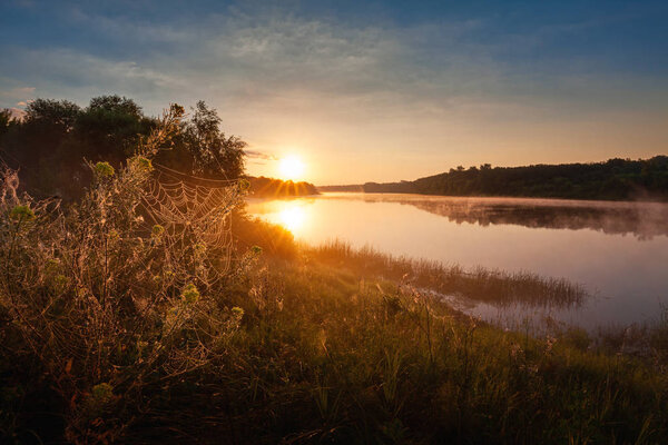 Sunrise landscape with foggy river