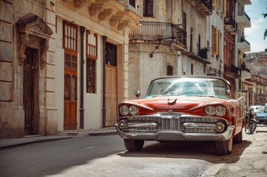 Havana, Küba caddesinde park etmiş eski model parlak bir araba.