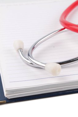 Tıbbi kavramı. Steteskop ve beyaz arka plan üzerine açık defter