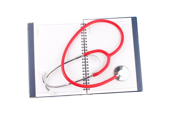 Conceito médico. Estetoscópio e caderno aberto sobre fundo branco — Fotografia de Stock