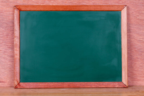 Green school chalkboard with written sentence spaces