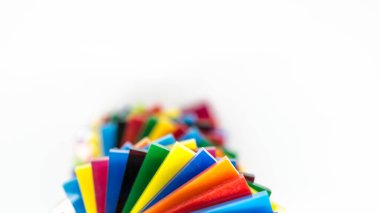 Stack of Coloured Cast Acrylic Sheet on white background, top view clipart