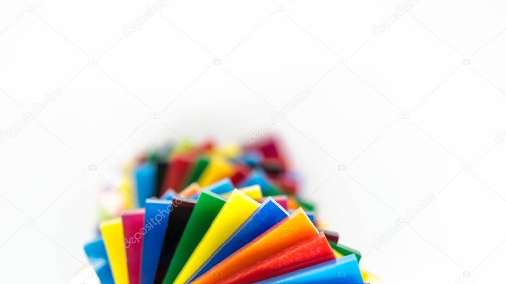 Stack of Coloured Cast Acrylic Sheet on white background, top view