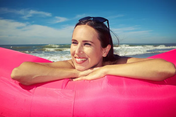 Attractive female is lying on her stomach while leaning her chin — Stock Photo, Image