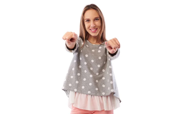 Stylish girl pointing with two index fingers at the camera while — Stock Photo, Image
