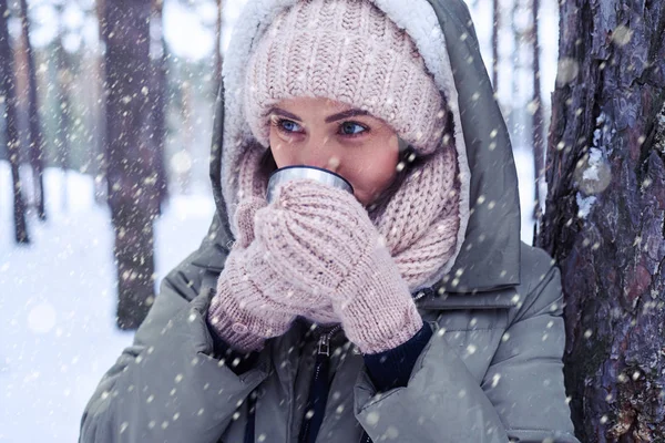 Schöne blauäugige Frau mit luxuriösem Make-up hält einen Becher mit T — Stockfoto