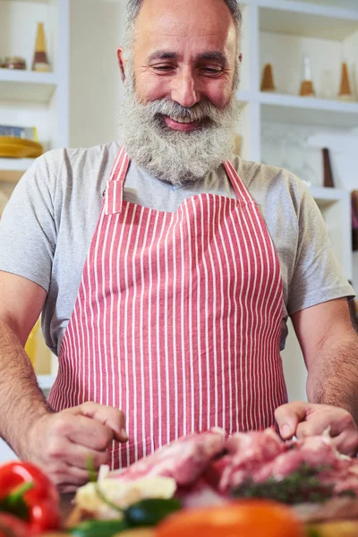 Mid shot of delighted man starting to prepare dinner for family — Stock Photo, Image