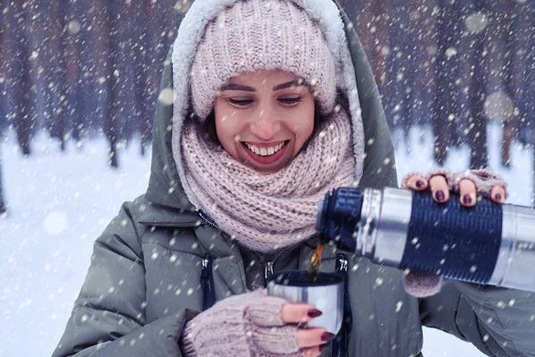 Mujer positiva vertiendo té de termos en taza — Foto de Stock