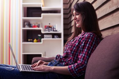 Netbook ekrana bakarken kalçalarına tutan kız 