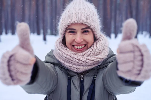 Close-up of delightful woman showing thumbs up to the camera — Stock Photo, Image