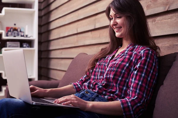 Glückliche Frau, die zu Hause am Laptop arbeitet — Stockfoto