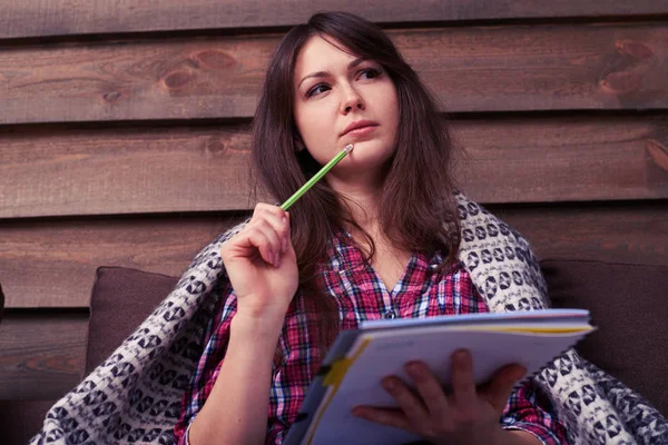 Pensive student holding pencil in hand near chin with doubtful e — Stock Photo, Image