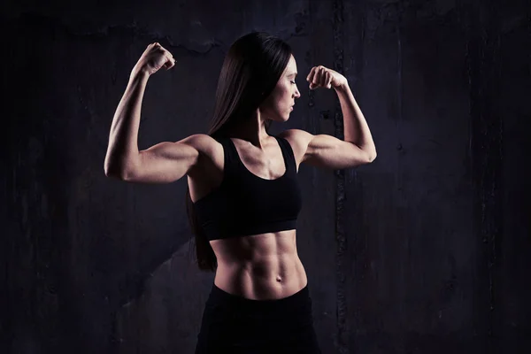 Close-up shot of woman flexing muscles showing great relief of a Stock Photo