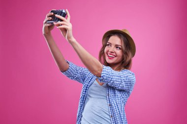 Selfie gümüş bir vintage fotoğraf makinesi ile yapma sevinçli casual kız 