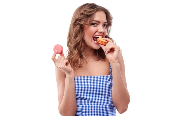 Очаровательная девушка кусает макарон — стоковое фото