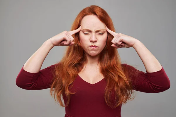 DSC _ 4964 _ Andry woman with auburn hair pressing her forehead with — стоковое фото