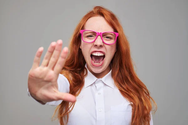 Gritando furioso pelo rojo chica muestra señal de stop por su mano — Foto de Stock