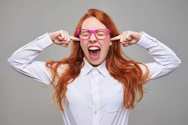 Furious girl closing ears with index fingers — Stock Photo, Image