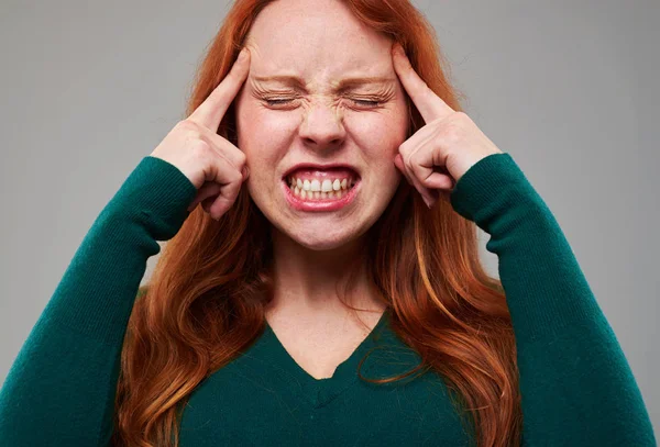 Stressed young redhead woman pressing fingers on forehead trying — Stock Photo, Image