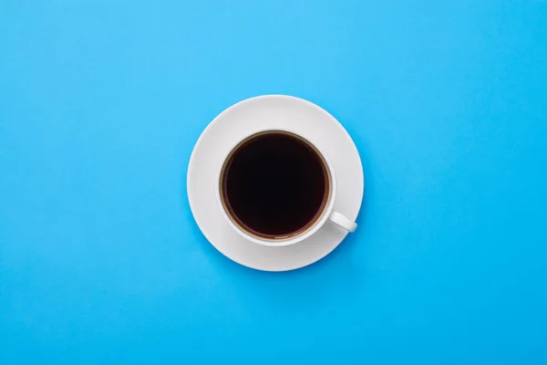Vista superior de un café de sabor oscuro aislado sobre plano azul —  Fotos de Stock