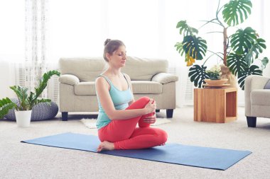 Genç sporcumuz yoga yaparken balık poz yoga mat