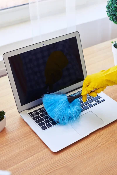 Woman dusting with small broom laptop — Stock Photo, Image