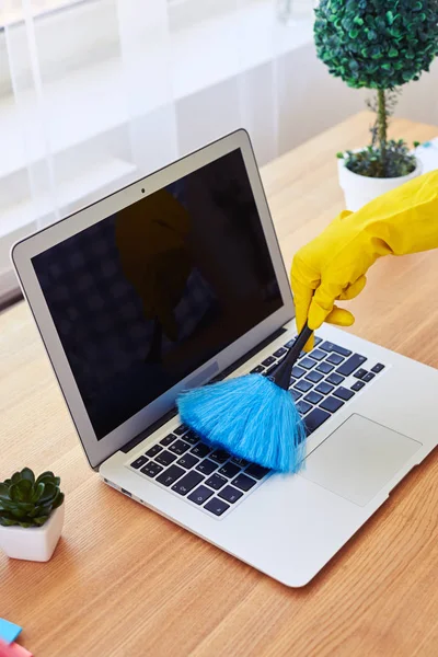 Girl in gloves dusting with small broom keyboard — Stock Photo, Image