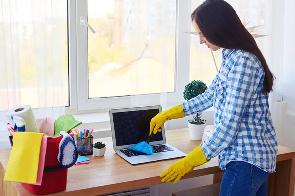 Appealing lady dusting with small broom keyboard — Stock Photo, Image