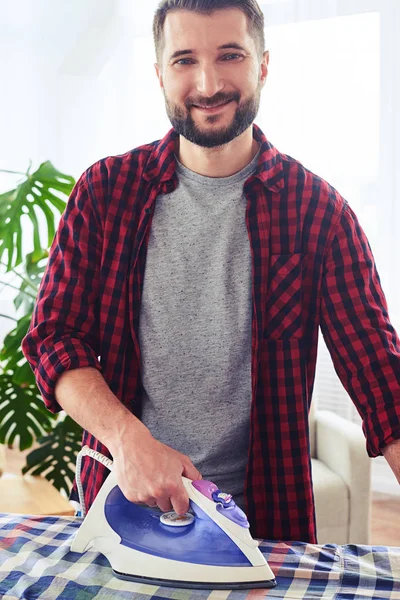 Bearded sir ironing attentively shirt on board — Stock Photo, Image