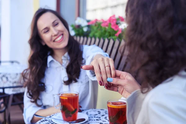 Pleased woman showing wedding ring to friend — Stock Photo, Image