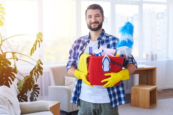 Smiling guy holding nice set for cleaning — Stock Photo, Image