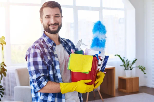 Good-looking male holding nice set for cleaning — Stock Photo, Image