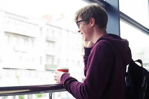 Sorrindo homem falando no telefone e segurando xícara de café — Fotografia de Stock