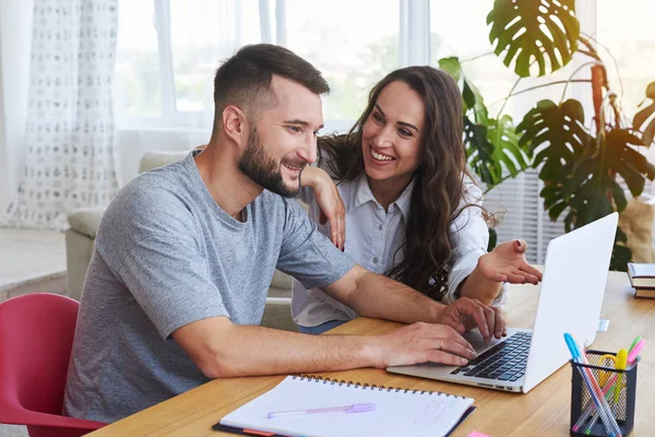 Charming female and male discussing while working in laptop — Stock Photo, Image