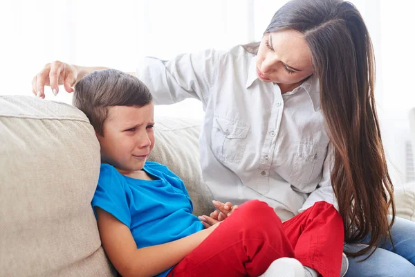 Joven madre tratando de confortar y calmar a su hijo llorando — Foto de Stock