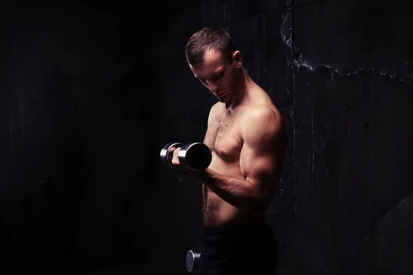 Barbusiger muskulöser junger Mann, der mit einer Hantel trainiert — Stockfoto