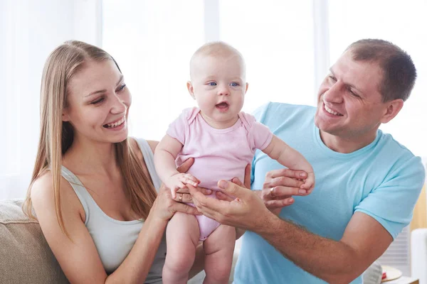 Mother and fatherholding small baby — Stock Photo, Image