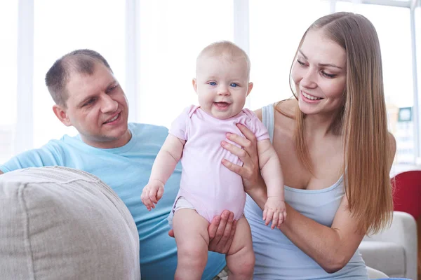 Kedves anya gazdaság baba ülve apa kanapé — Stock Fotó