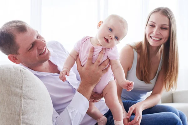 Good-looking father holding fantastic baby while sitting with wi — Stock Photo, Image
