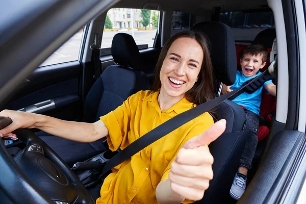 Smiling mum driving a car