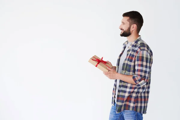 Side view of happy bearded man holding present box — Stock Photo, Image