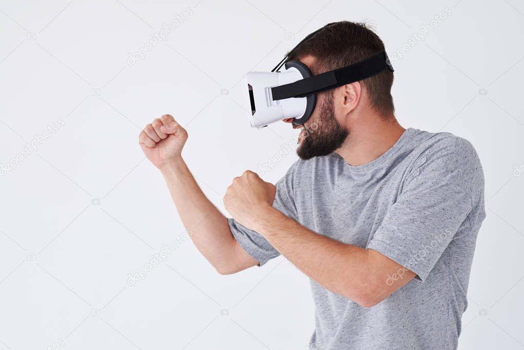 Man in VRG glasses playing a sport fight video game