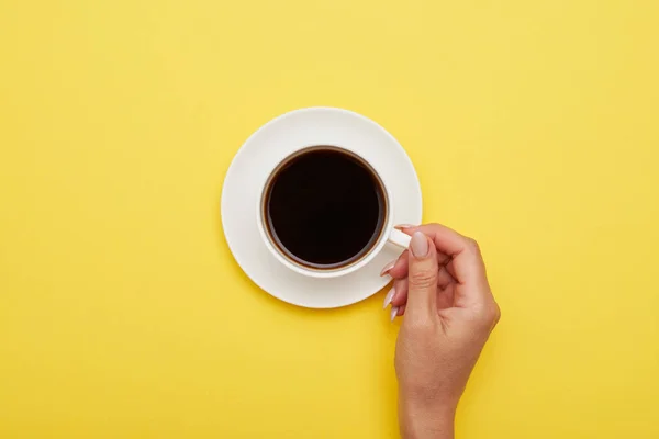Girl hand holding cup of tasty espresso, flat lay — Stock Photo, Image
